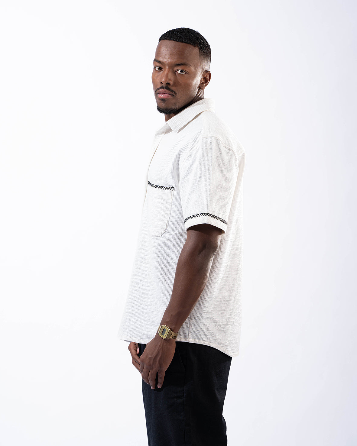 White half sleeve shirt with black line from the sleeve and pocket